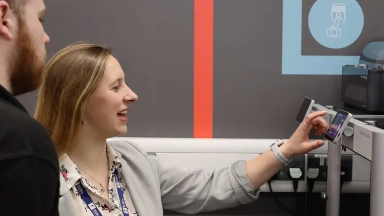 Elizabeth Bishop, Ph.D. demonstrating machine operation to a University of Nottingham student