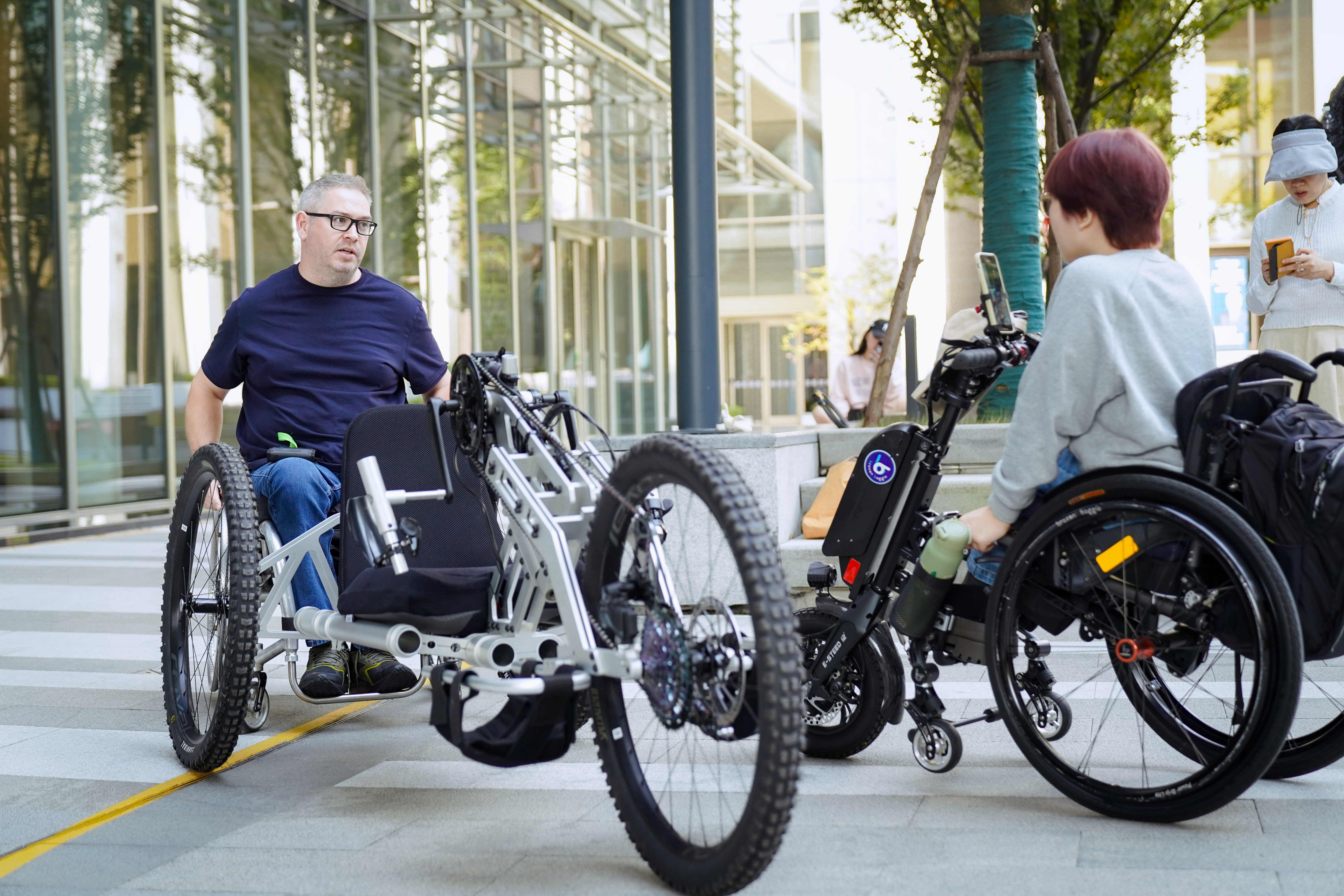 Two people riding on an adaptive bike