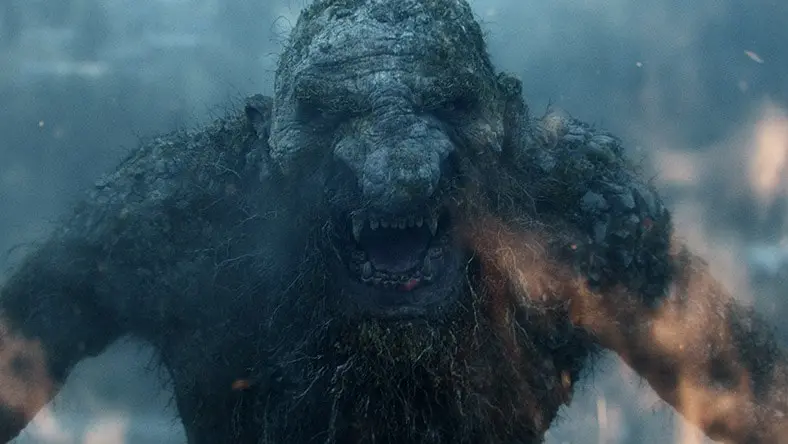 A monster roars in a dark forest.