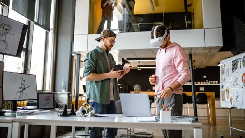 Group of coworkers testing VR simulator in the office