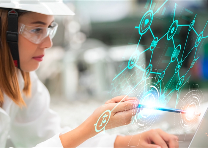 Collage of woman in safety goggles and hard hat working on computer with graphic overlay representing Industry 5.0 manufacturing trends 2022