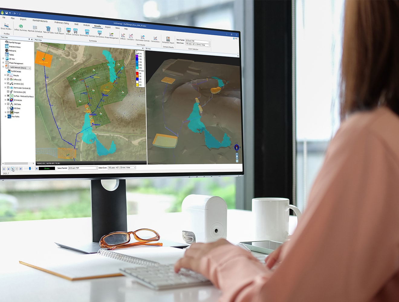 an engineer is working with InfoDrainage software at the desk