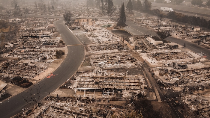 A photo shows a town completely leveled by wildfire.