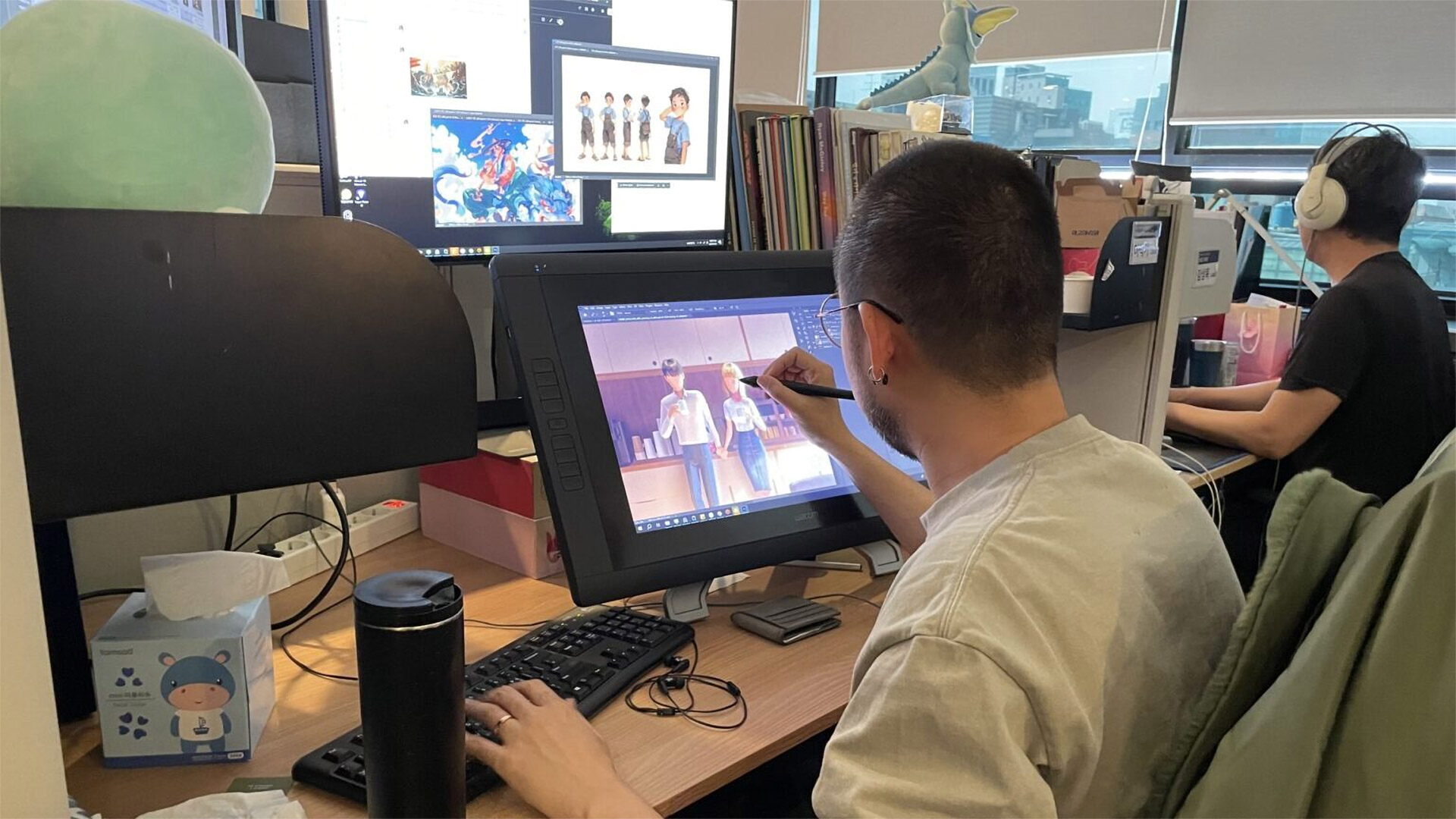 A LOCUS Animation artist drawing on an iPad at their desk