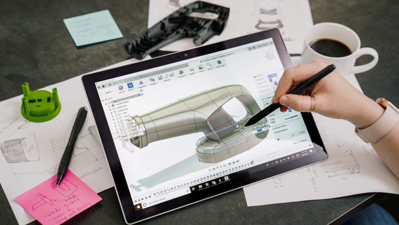 Woman marking up a design using cloud collaboration tools in Autodesk Fusion.