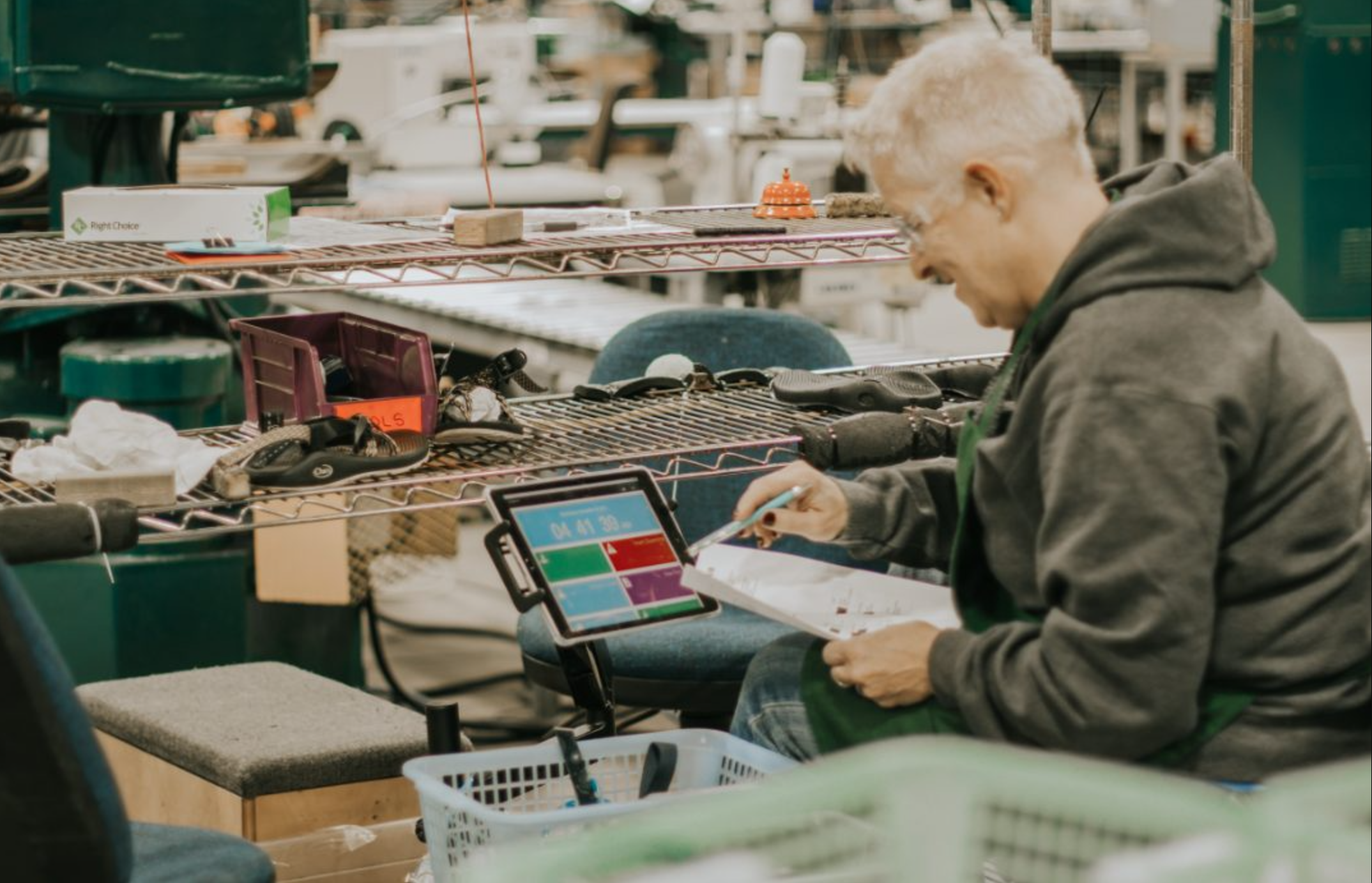Photo of a ReChaco employee using Autodesk Fusion Operations on a tablet at his assembly workstation.