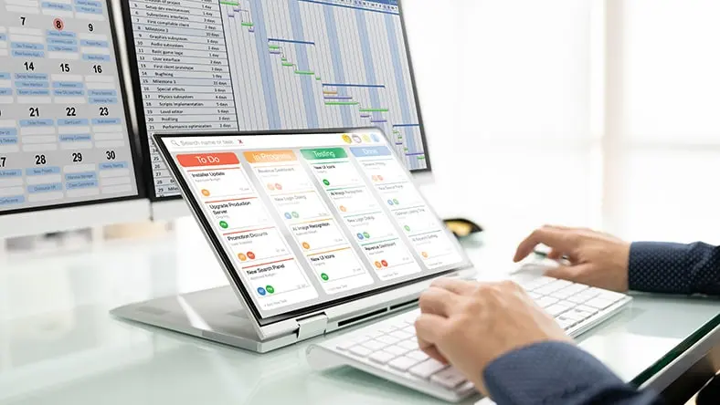 An office worker reviews project scheduling software.