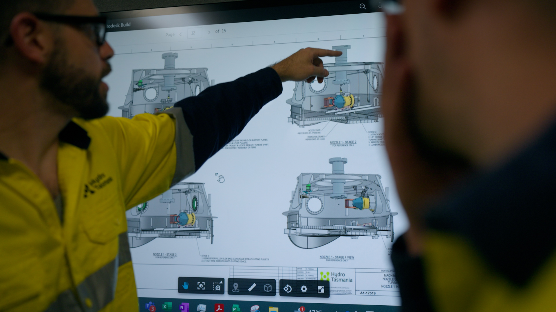 Julian Quinn discussing technical schematics on display.