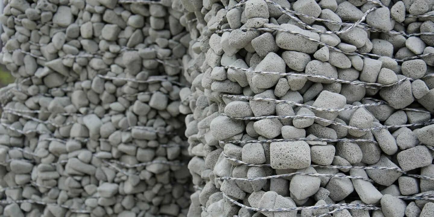 Close-up view of small rocks bound together to create a large structure.