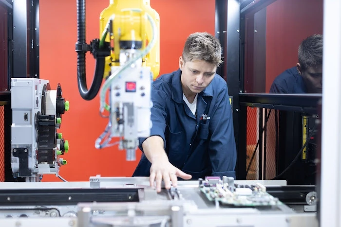 man works on machine in microfactory