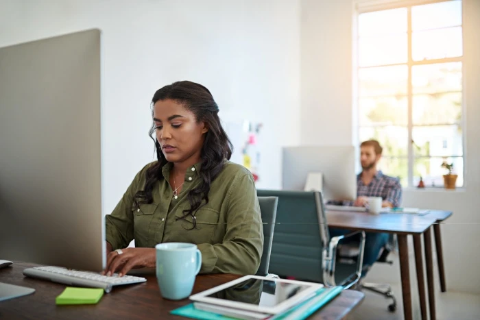 Shot of a female designer working on her computer in a modern office