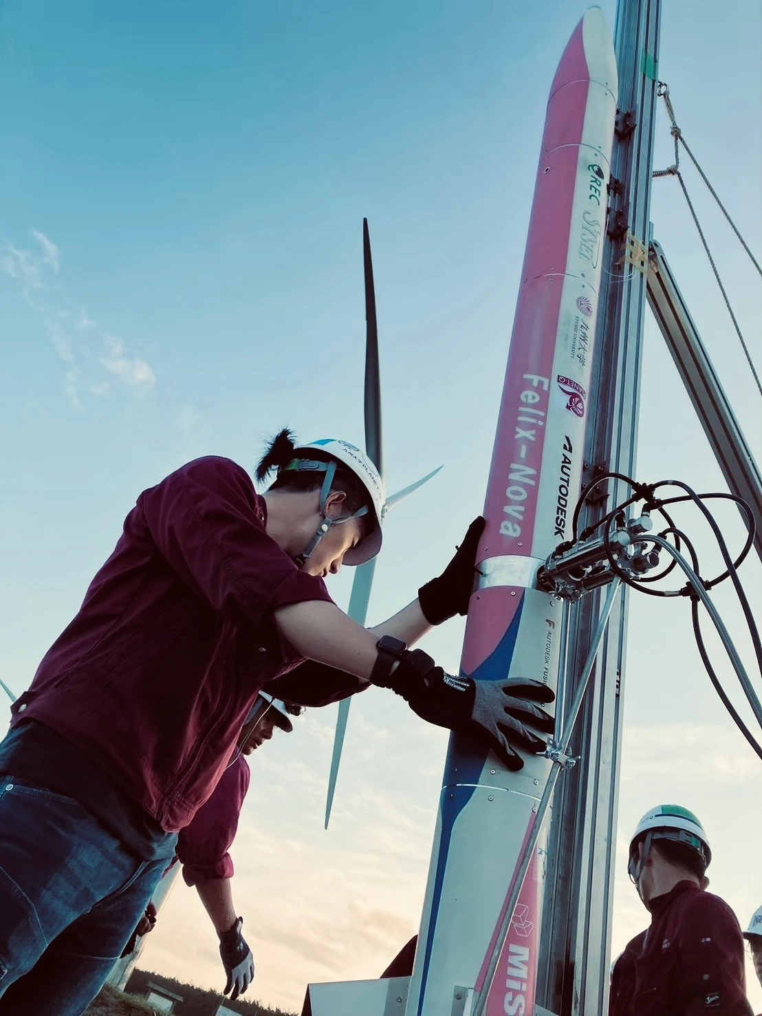 PLANET-Q team members with rocket.
