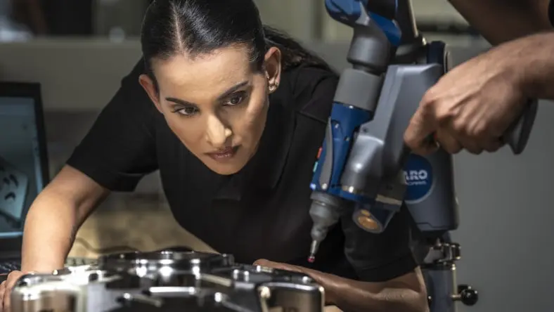 women looking intensely at a tool
