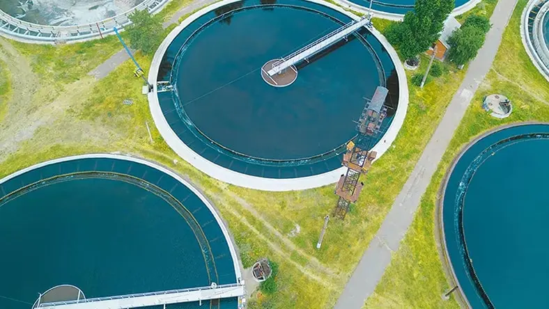 An overhead photo shows water tanks at a power station.