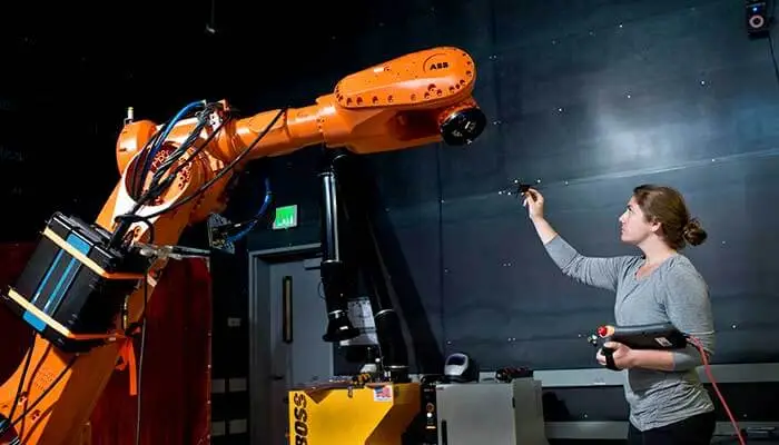 A human manufacturing worker training with a AI-powered counterpart