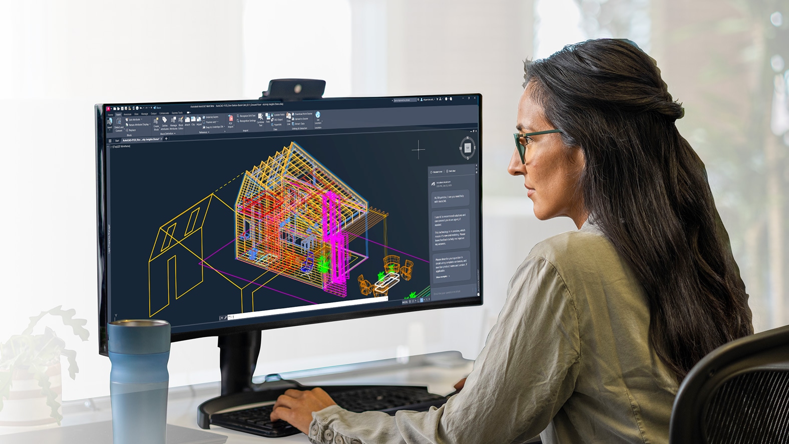 A woman works on a section of an AutoCAD design file