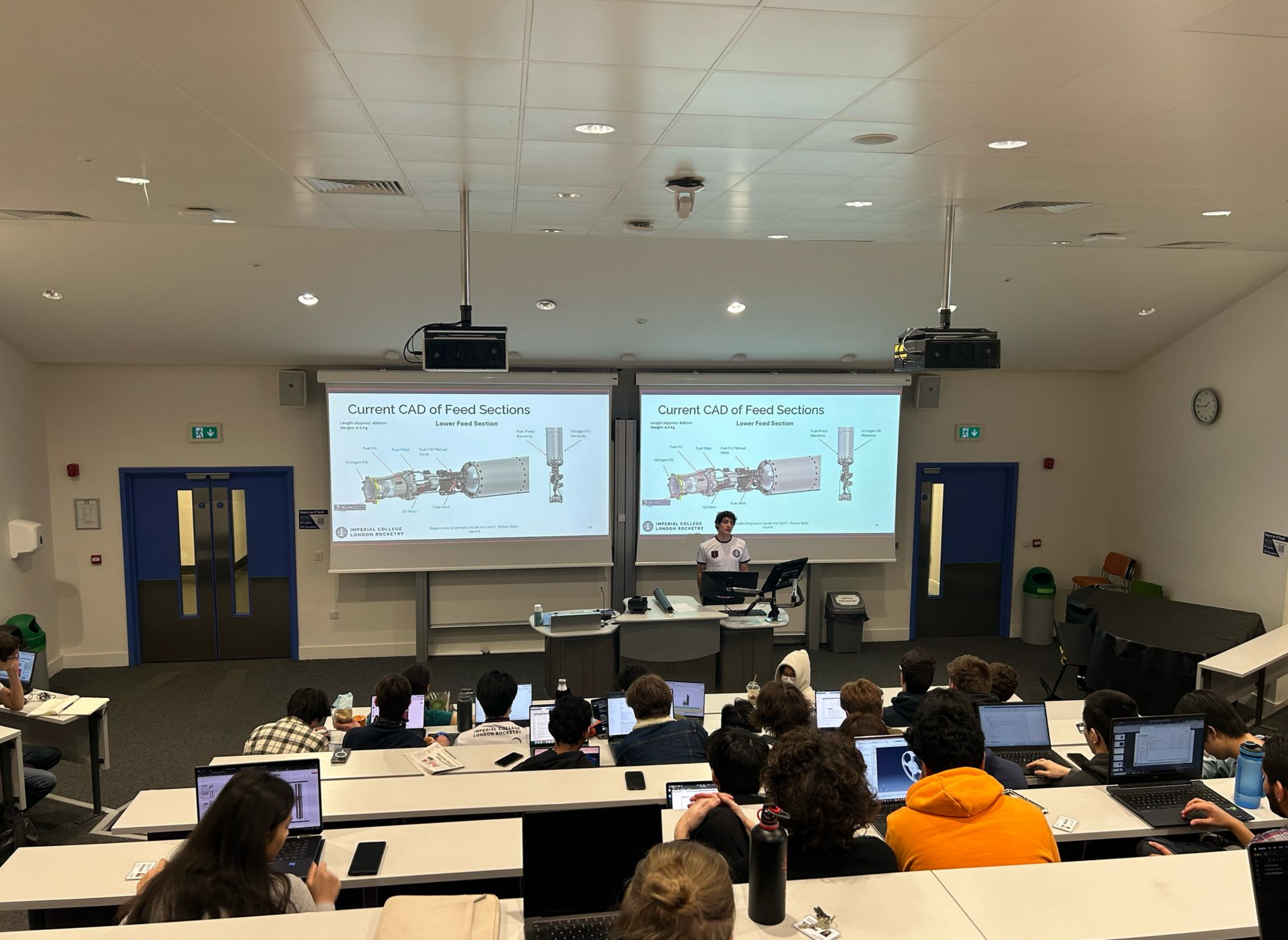 Student presenting on latest ICLR rocket design in classroom
