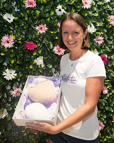 Woman holds packaged myReflection breast prosthesis