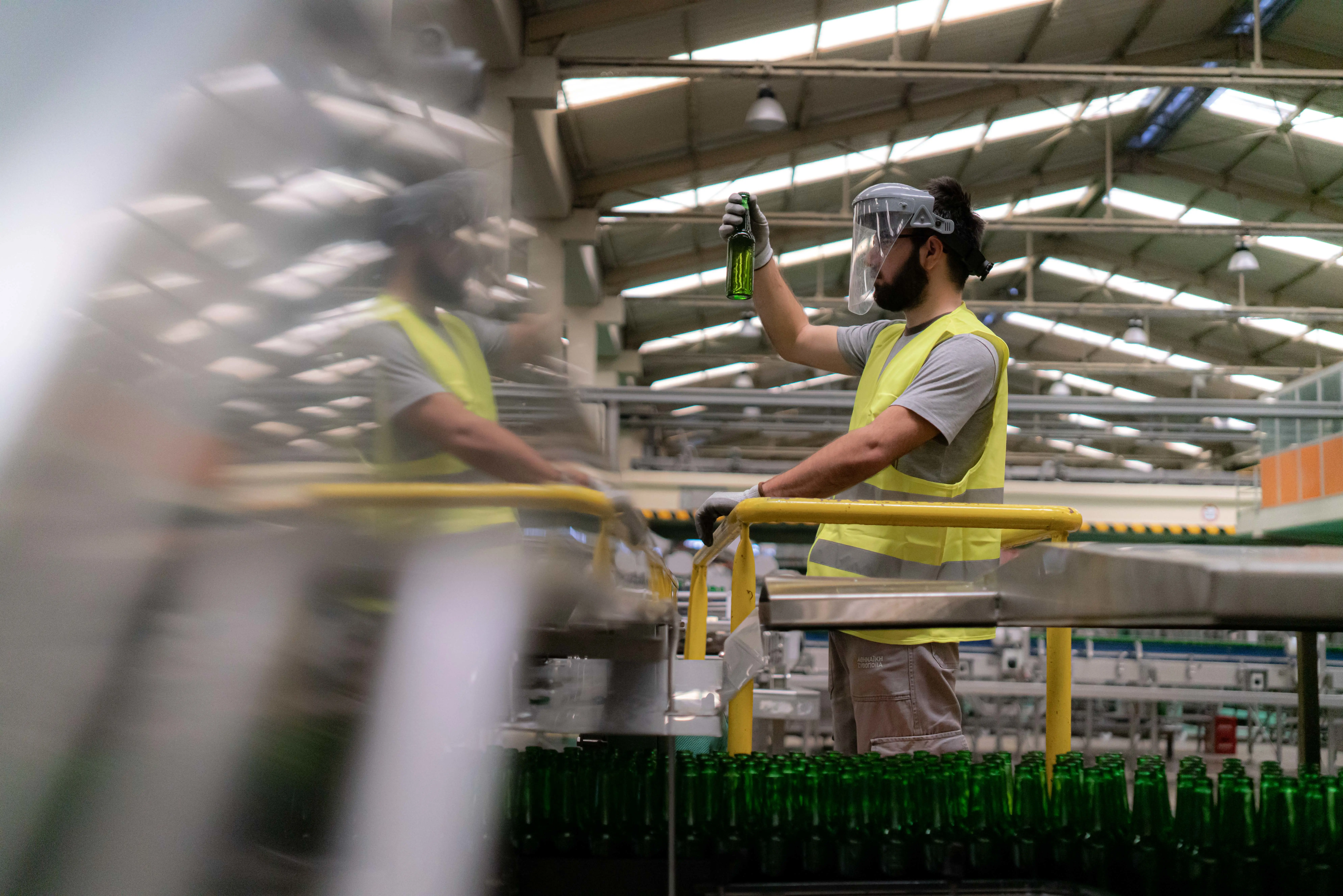 A brewery worker performing quality checks