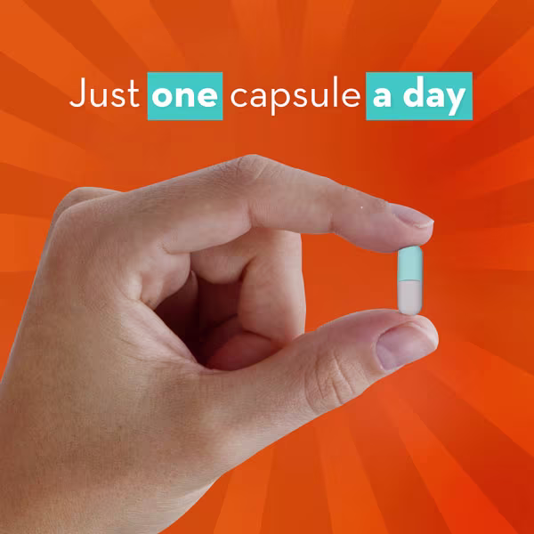 A hand holding a pill, with text "Just one capsule a day".