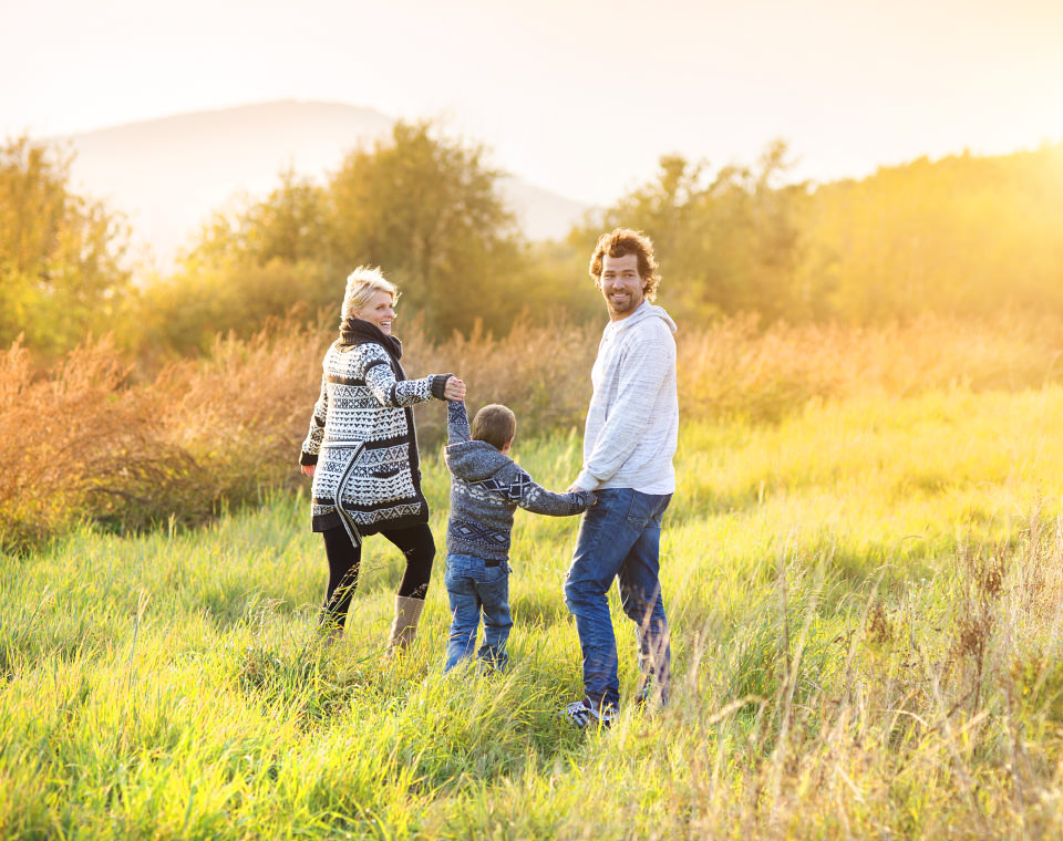 happy-family-running-through-field-i-screen