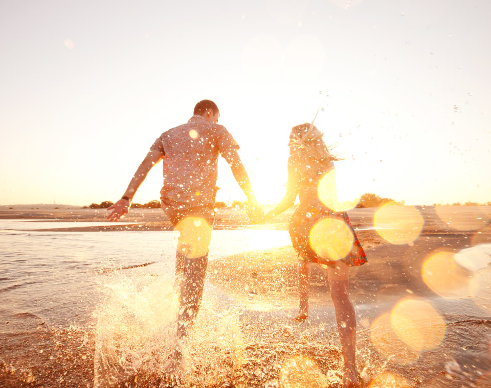 couple-running-through-water-on-sunny-day-i-screen