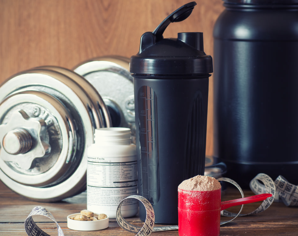 weights-tape-measure-and-supplements-on-table-i-screen