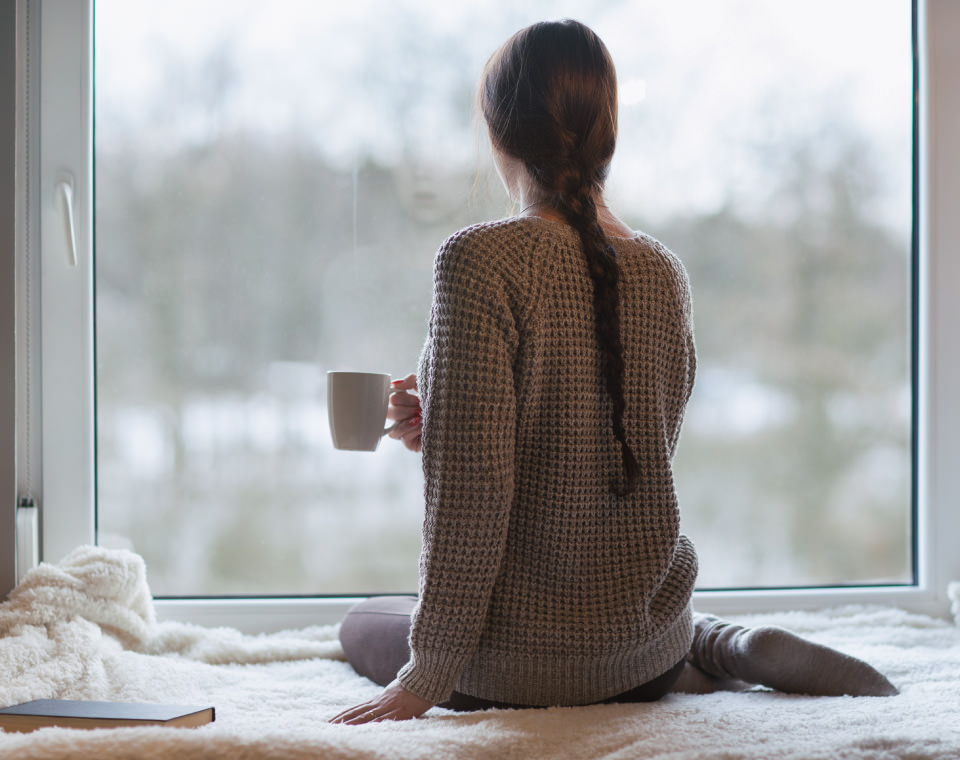 woman-drinking-coffee-looking-out-window-i-screen