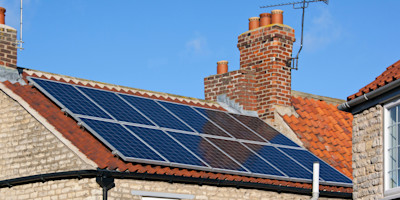 An image of a house with solar panels on the roof