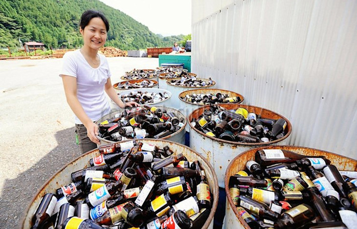 Villagers sort bottles at the 'Zero Waste Academy'