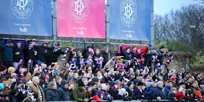 Dulwich Hamlet fans celebrating in front of Bulb banners