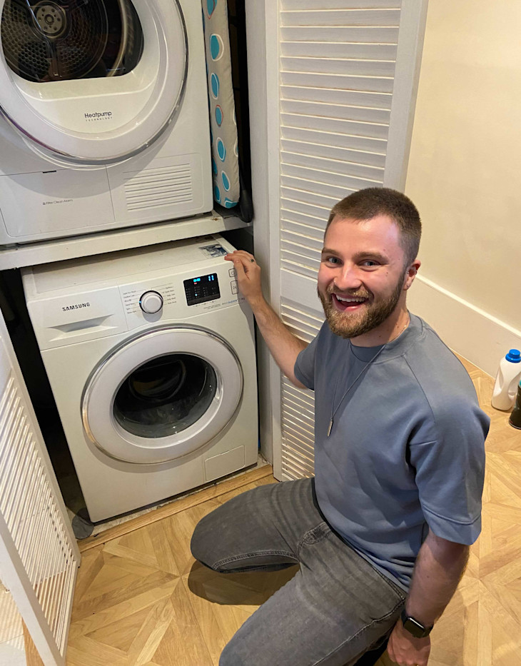 One of our team loading the washing machine at home.