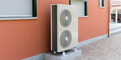 Heat pump against pink house