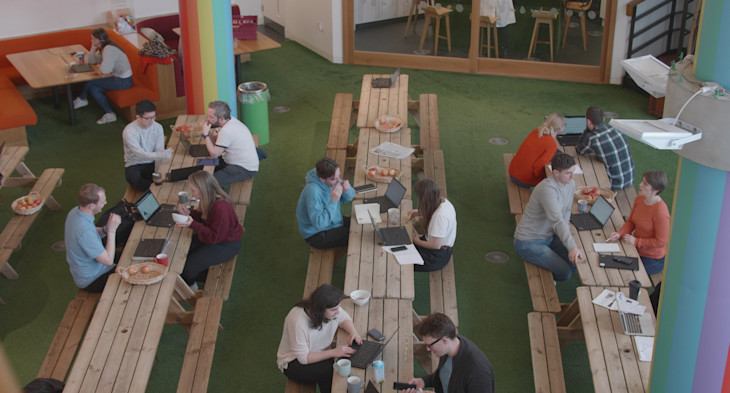 innocent team members eating lunch at picnic benches