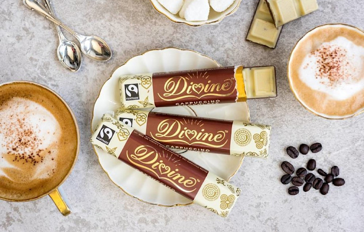 Three Divine chocolate bars alongside coffee
