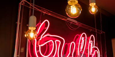 The Bulb logo, as a neon sign.