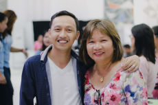 Cristina Sosso smiling together with a young Filipino man who attended the conference