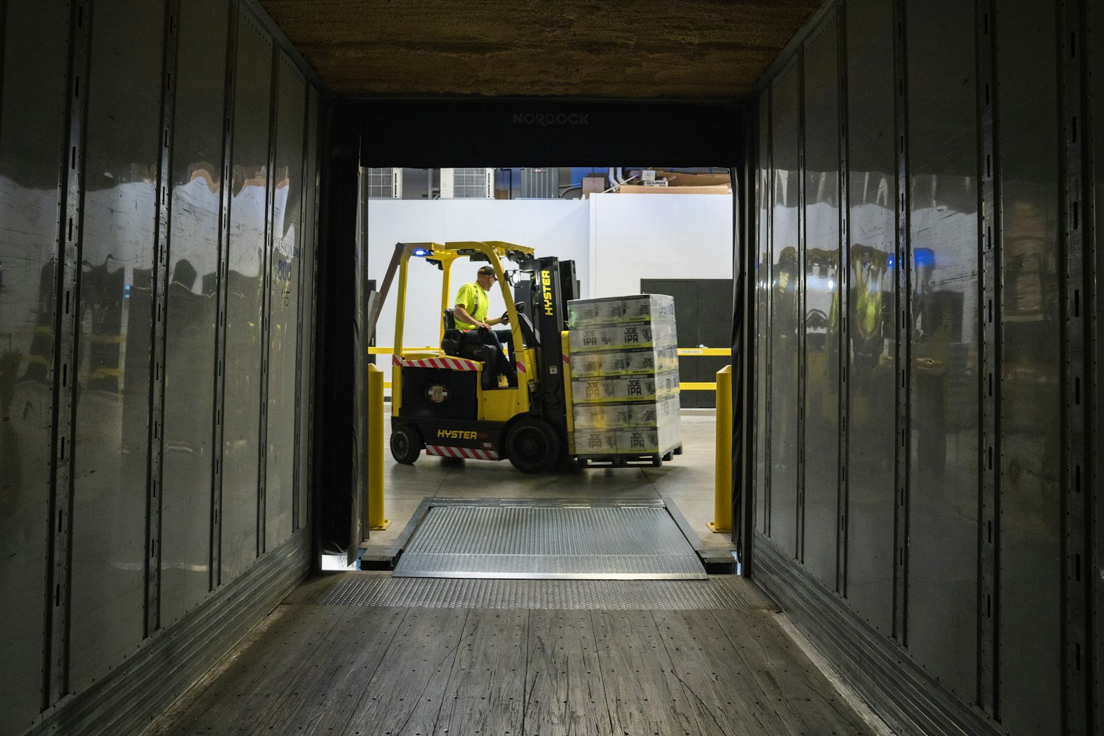 Forklift loading pallets into a truck trailer