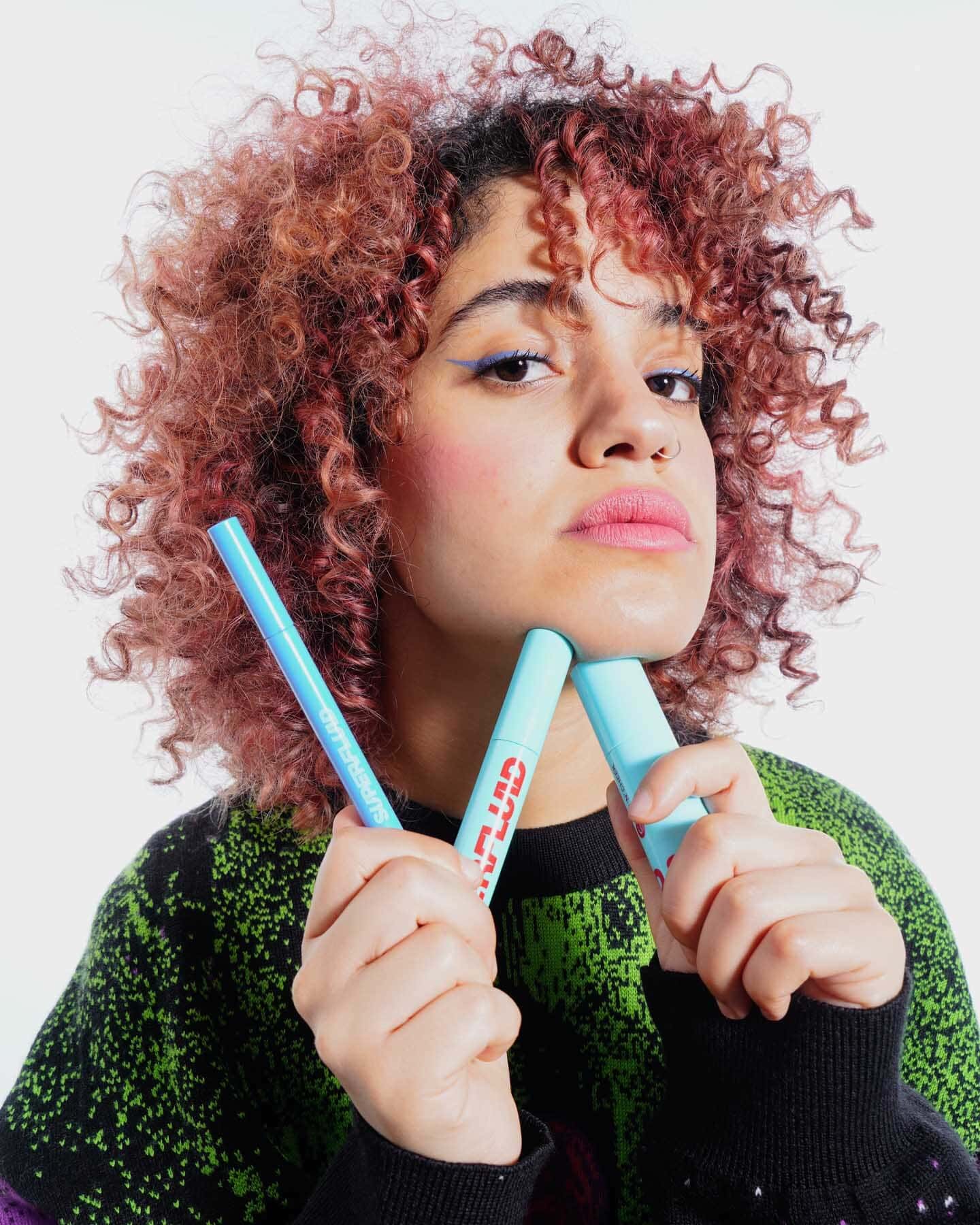 open packs of azure eye liner, mauve lip and cheek tint and black mascara