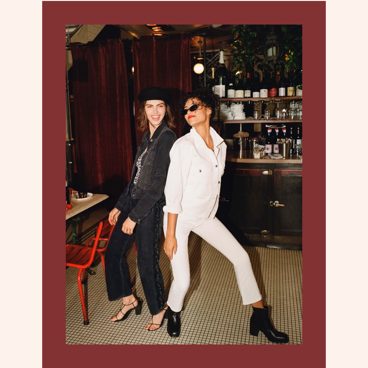 Two girls in a bar wearing head to toe denim. Pair a white denim jacket with white jeans.