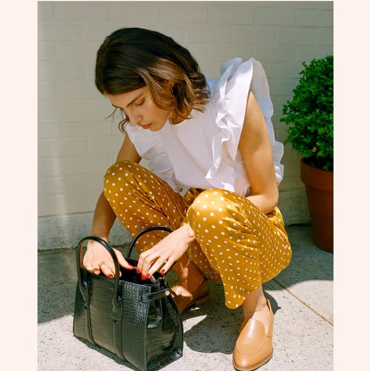 A white ruffled blouse and yellow polka dot trousers, taking you from work to cocktails.