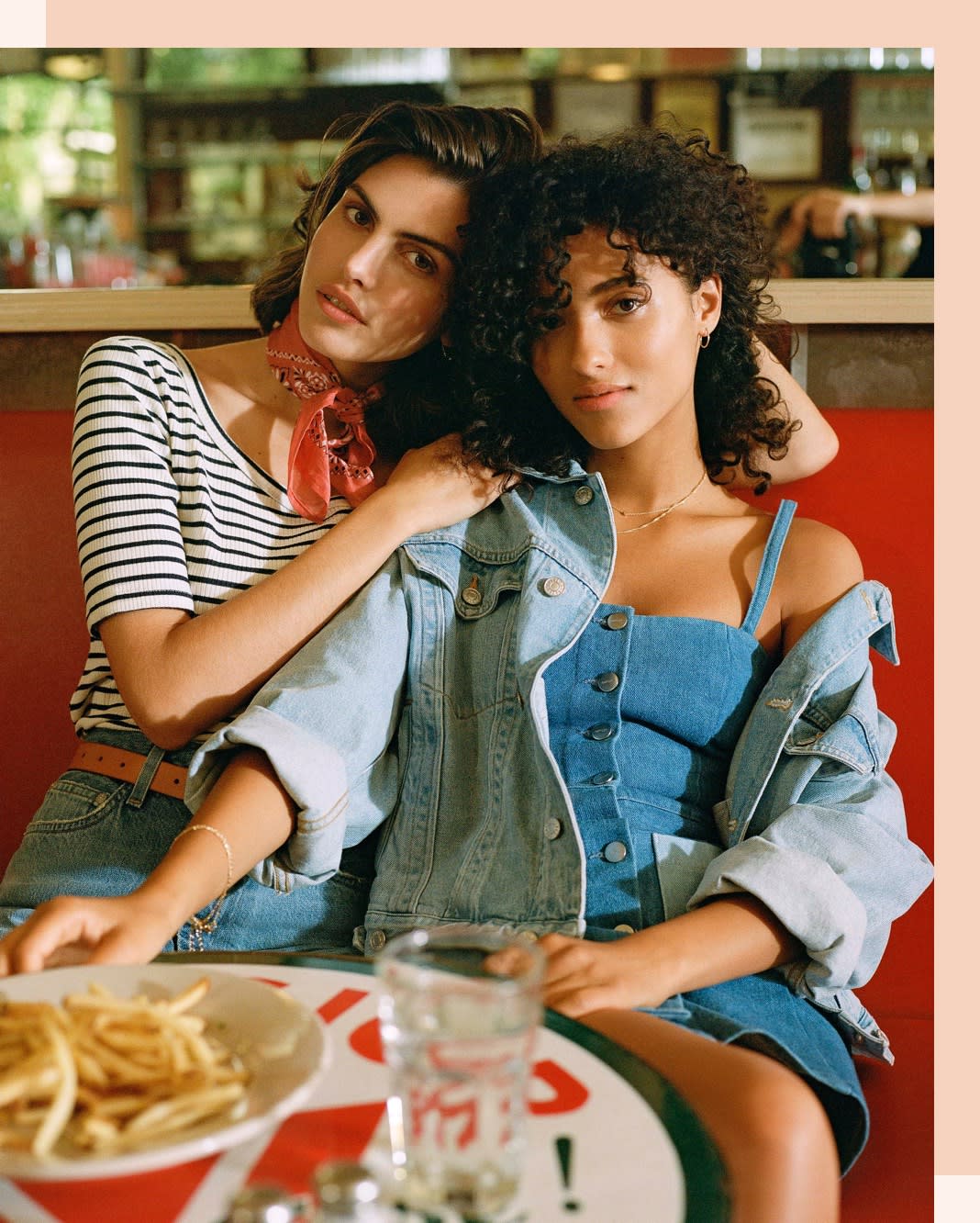 Two friends wearing denim, having dinner. Layer a denim jacket over a denim mini dress!