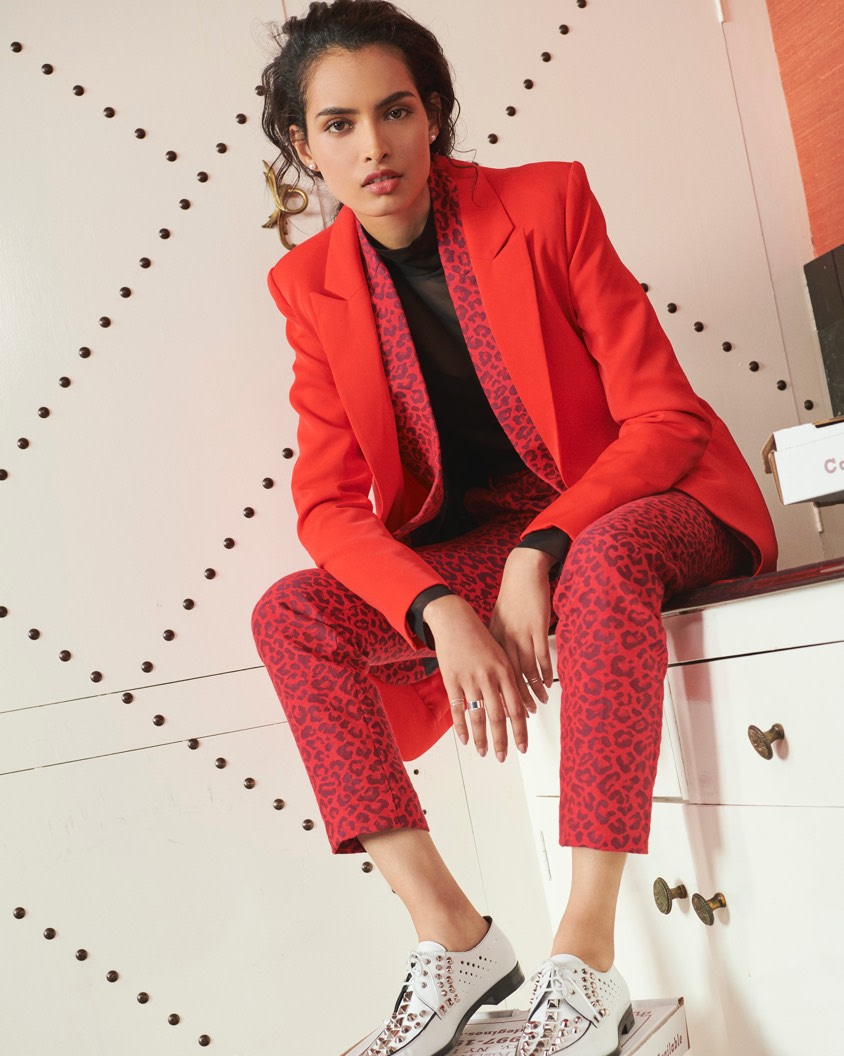 Layering red blazers with animal print pants.