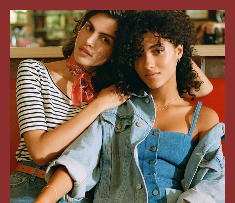 two models in denim outfits.