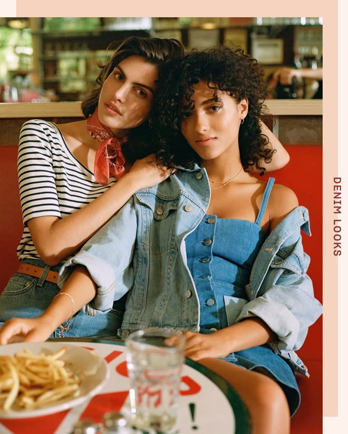 Two friends wearing denim, having dinner. Layer a denim jacket over a denim mini dress!