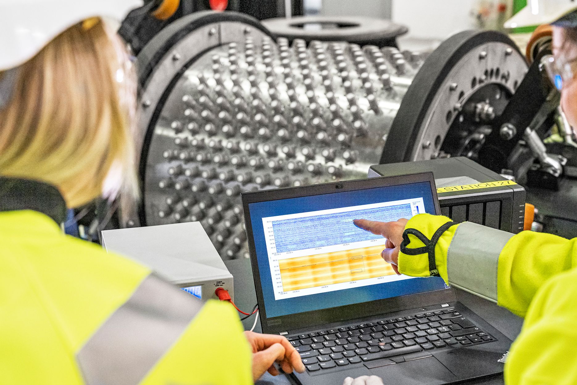 NDT Global employees inspecting data from a tool