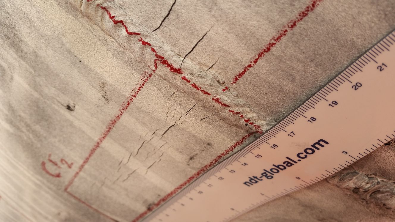 Up close image of a seam and cracks in a pipeline