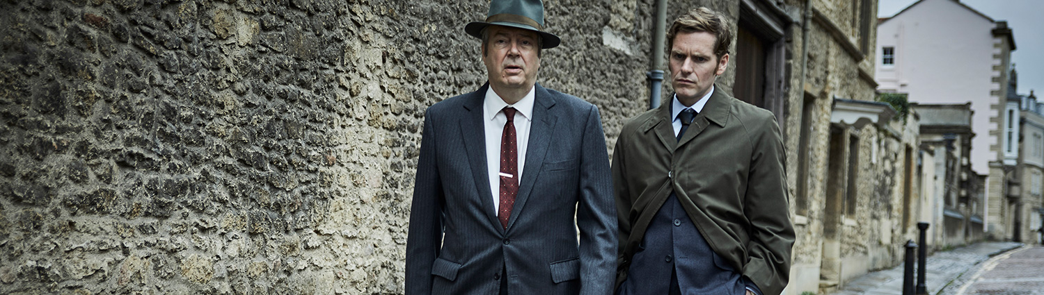Fred Thursday and Inspector Morse standing on a cobblestone street..