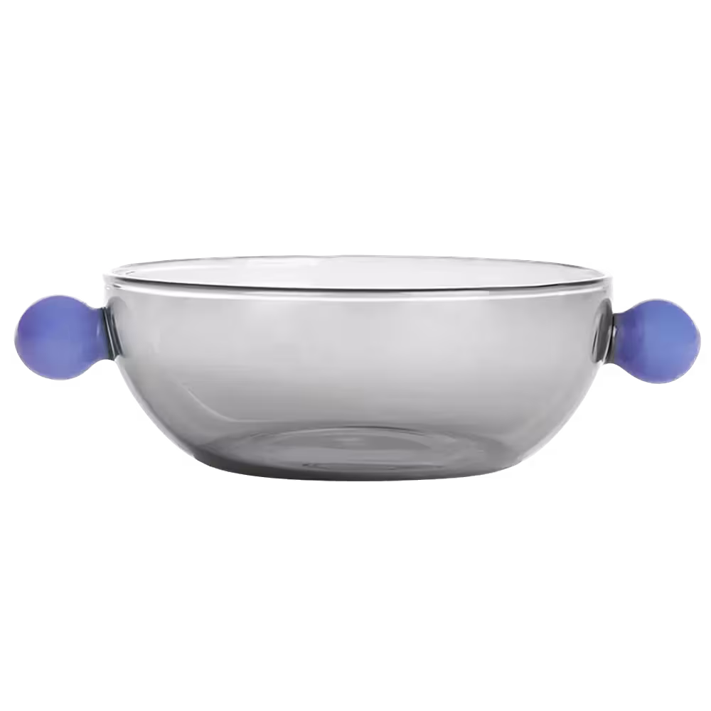 Clear glass bowl with rounded sides and two blue spherical handles on opposite sides, against a plain black background.
