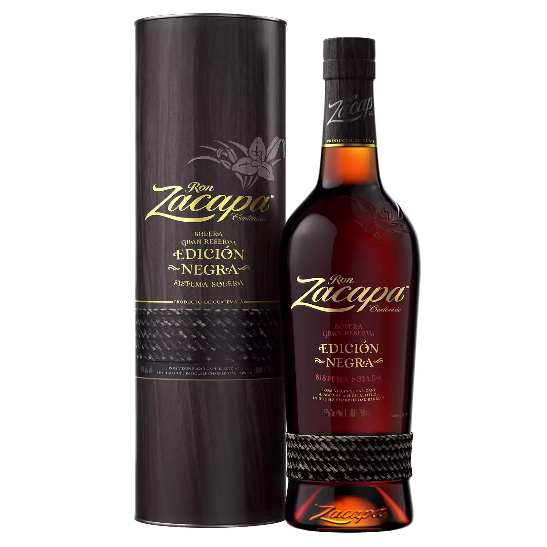 A bottle of Ron Zacapa Edición Negra rum stands next to its matching cylindrical black and gold box packaging, both featuring gold and red lettering.
